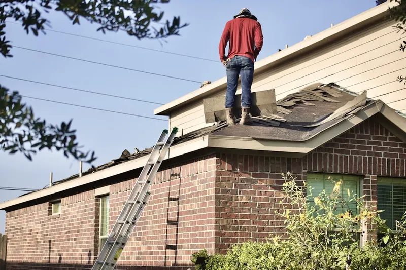 Professional roofer working on a residential roof in Bacton